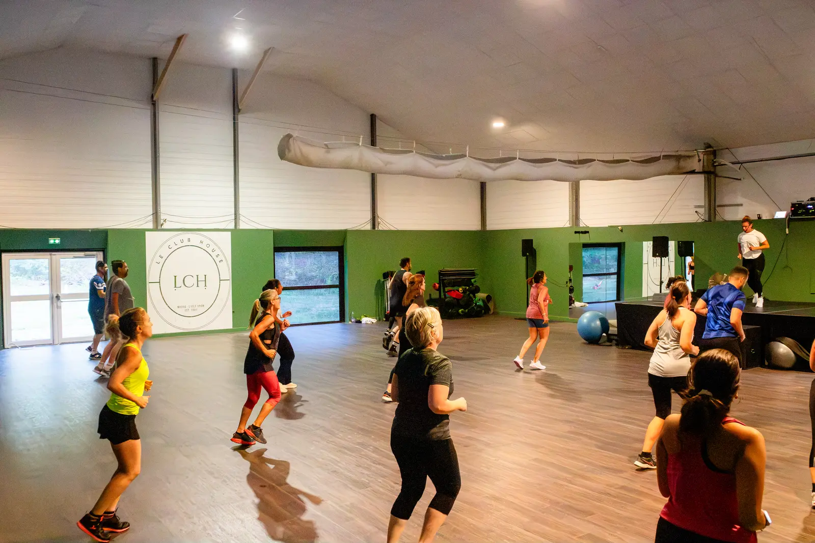 Cours de fitness en musique dans la grande salle du Club House